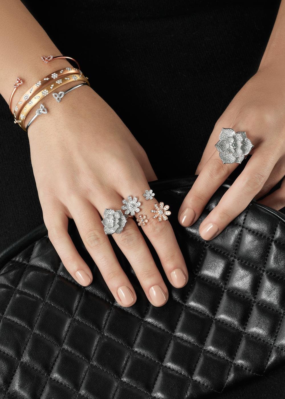 Product lifestyle photography of jewelry rings with hand model and black purse