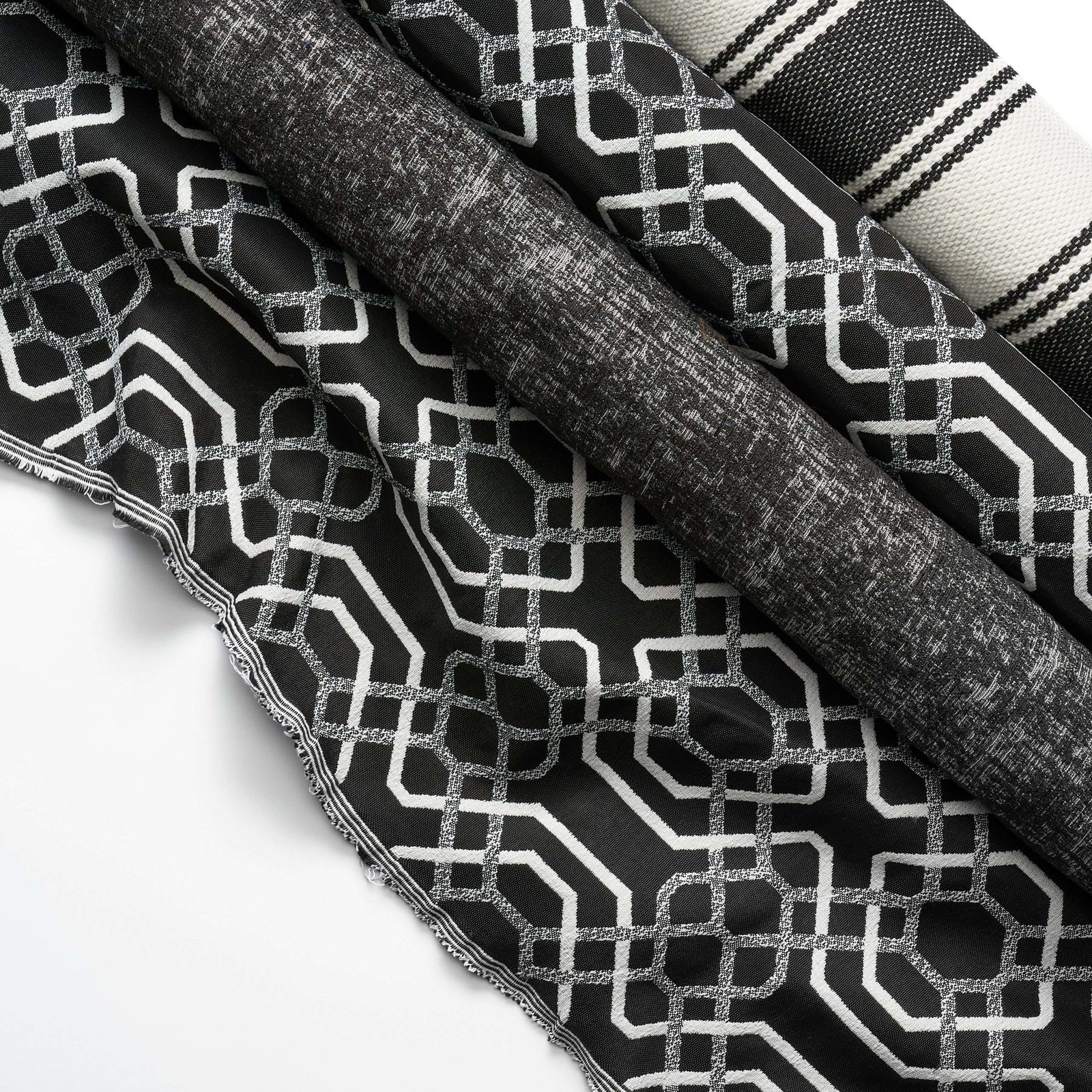Product lifestyle photography of black and grey colored fabric on white surface