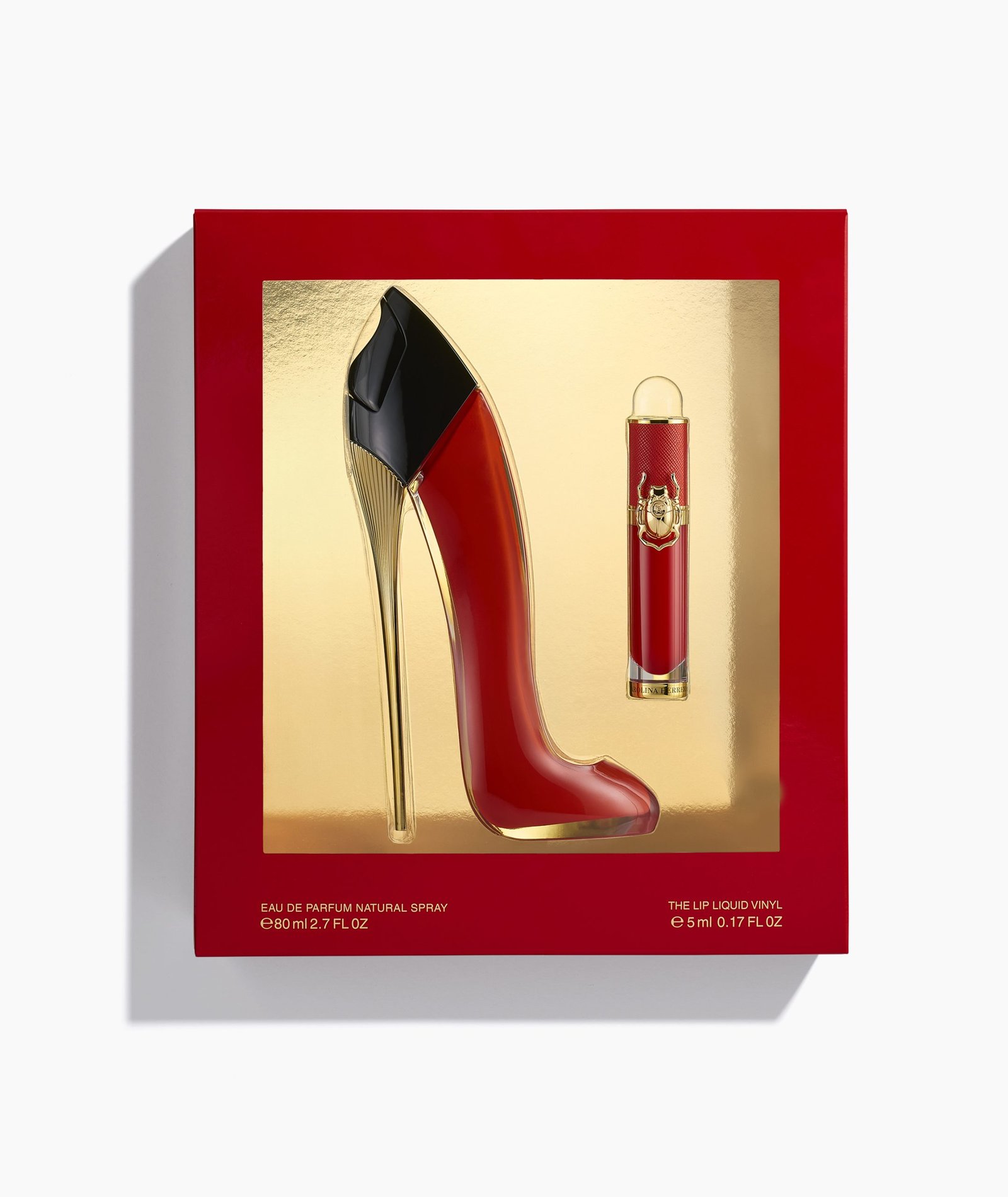 product photography on white surface of red high heel shoe perfume bottle lipstick in red and gold box with shadow