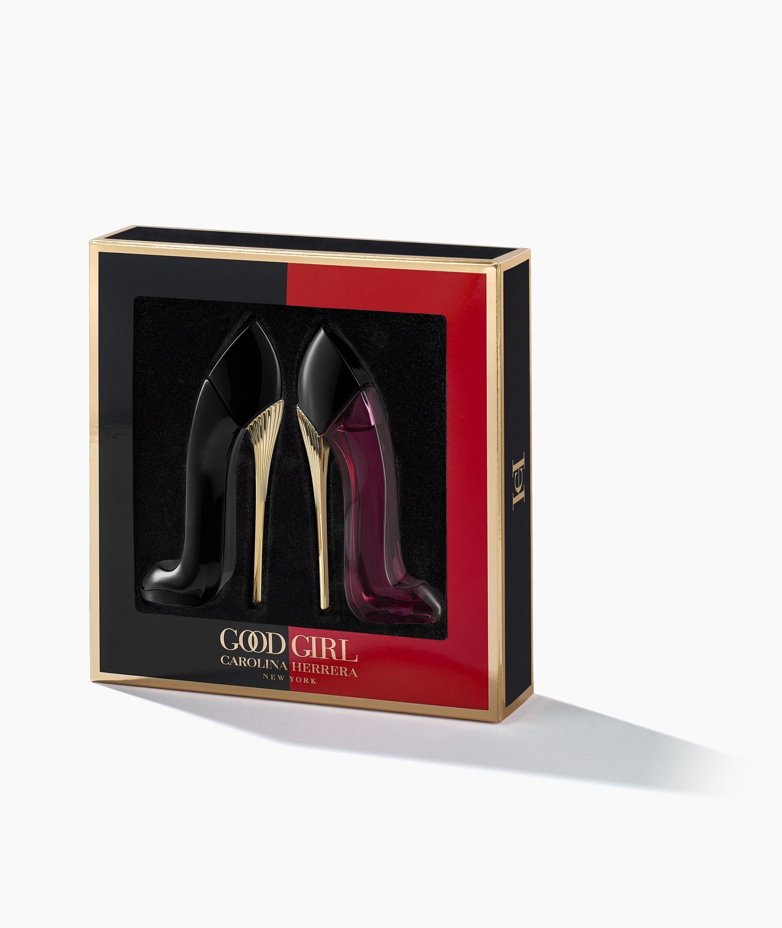 product photography on white surface of black high heel shoe perfume bottles in red and gold box with shadow