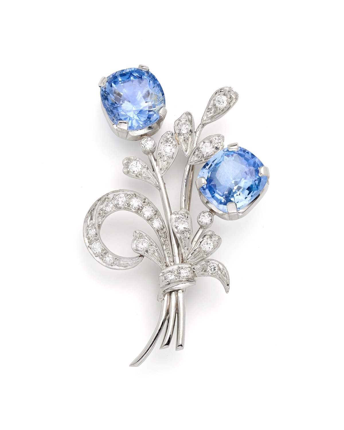 Product photography on white surface of sapphire and diamond pin