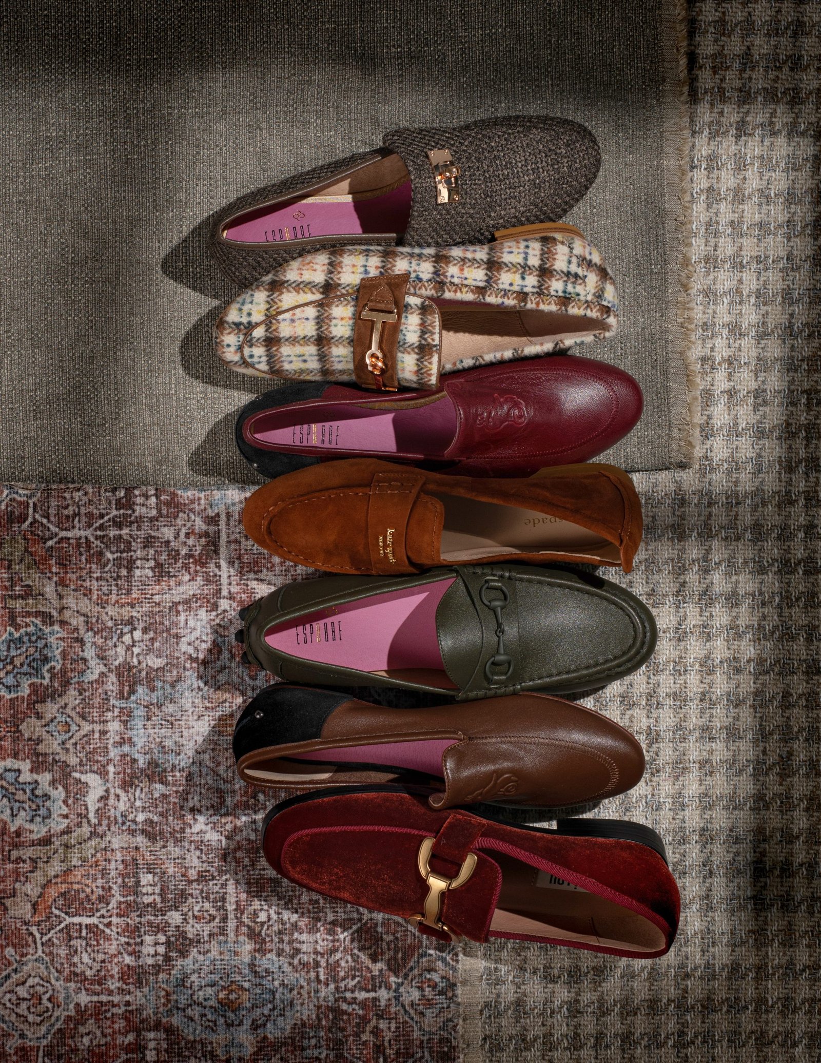 product lifestyle photography of black brown tan and patterned women's shoes on rugs with shadows