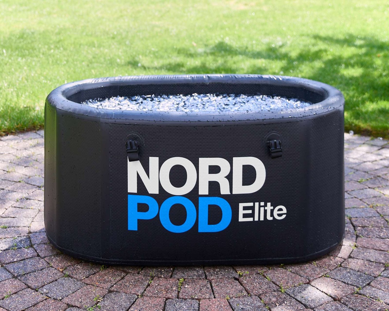 product lifestyle photography of ice tub on patio and grass backyard