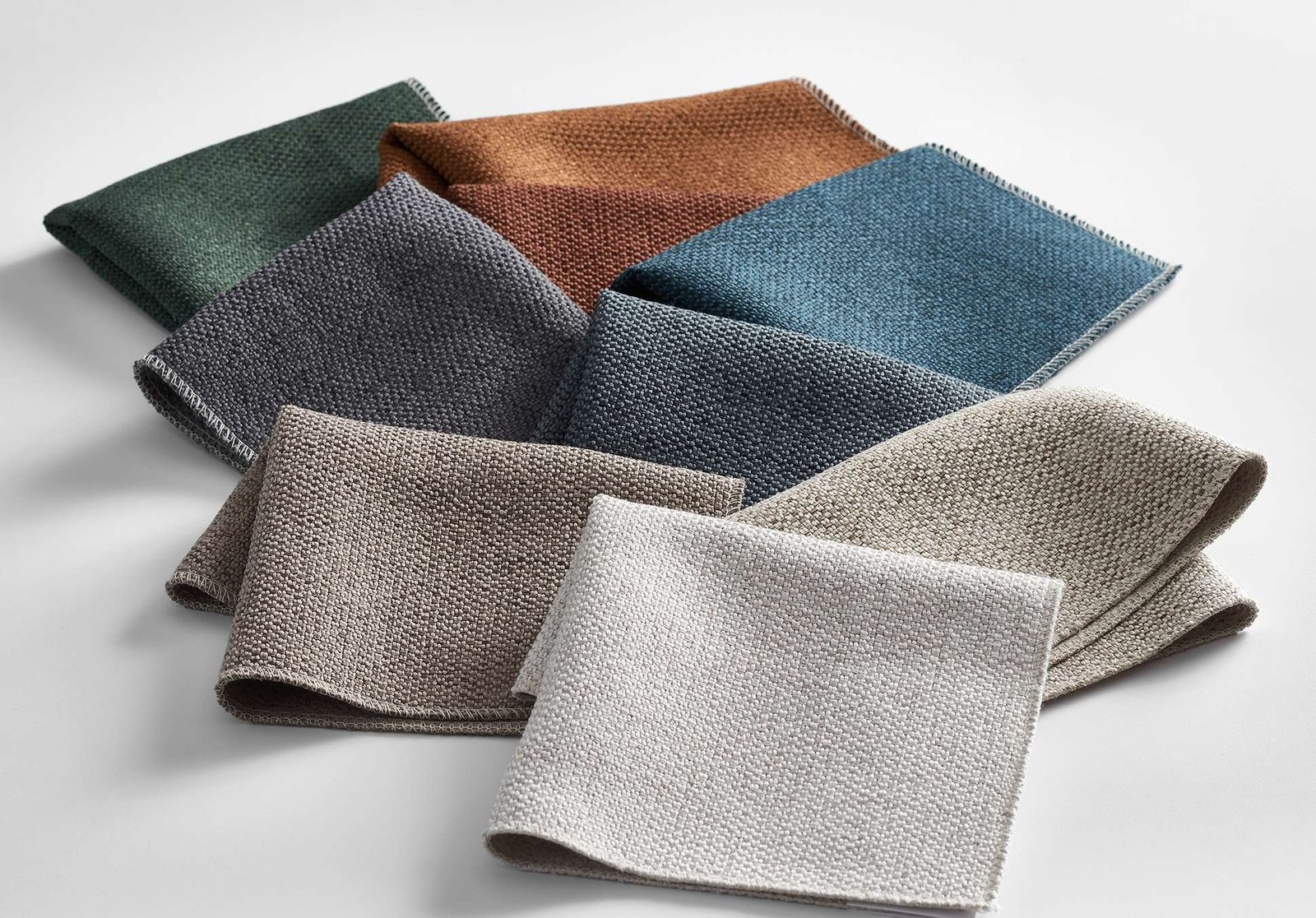 Product lifestyle photography of multi colored fabric swatches on white surface