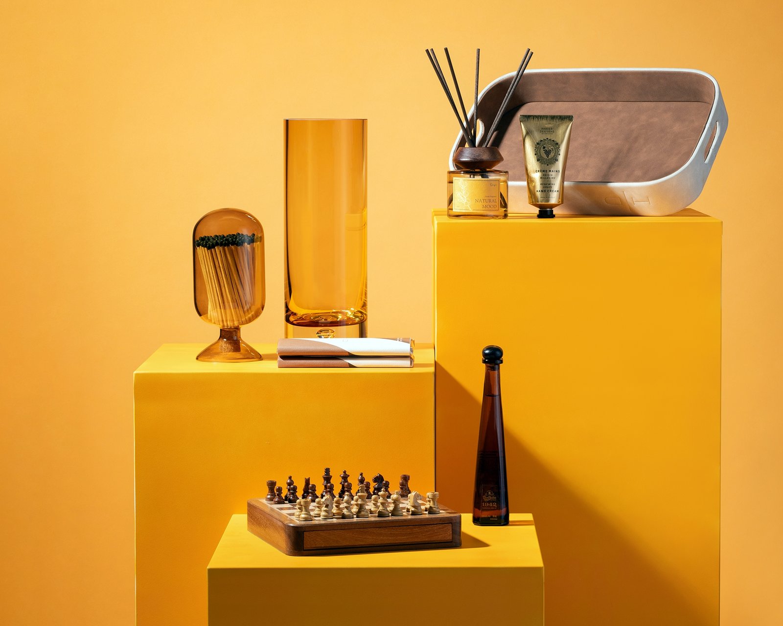 product lifestyle photography of gift ware on orange colored pedestals and orange colored background