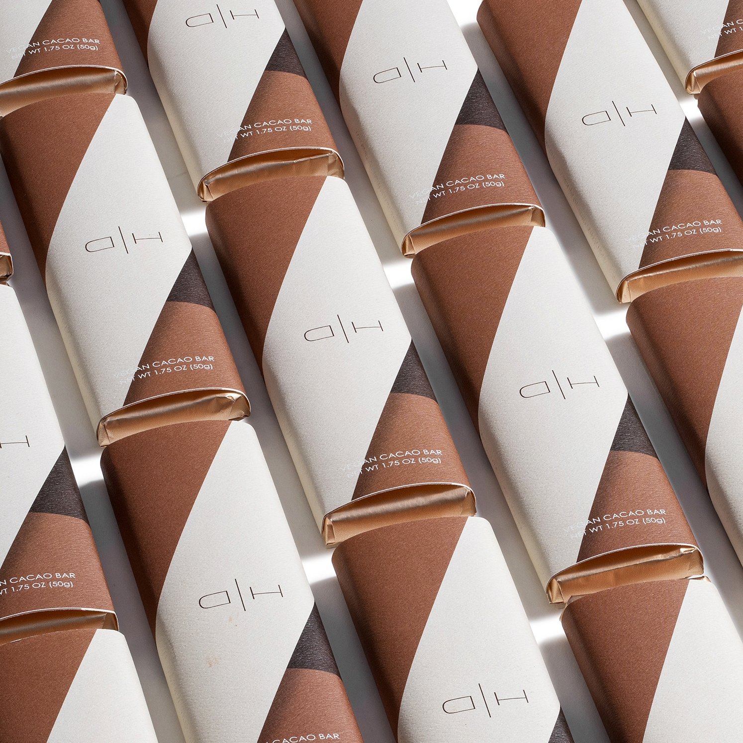 product photography of chocolate bars in wrappers in diagonal line on white background