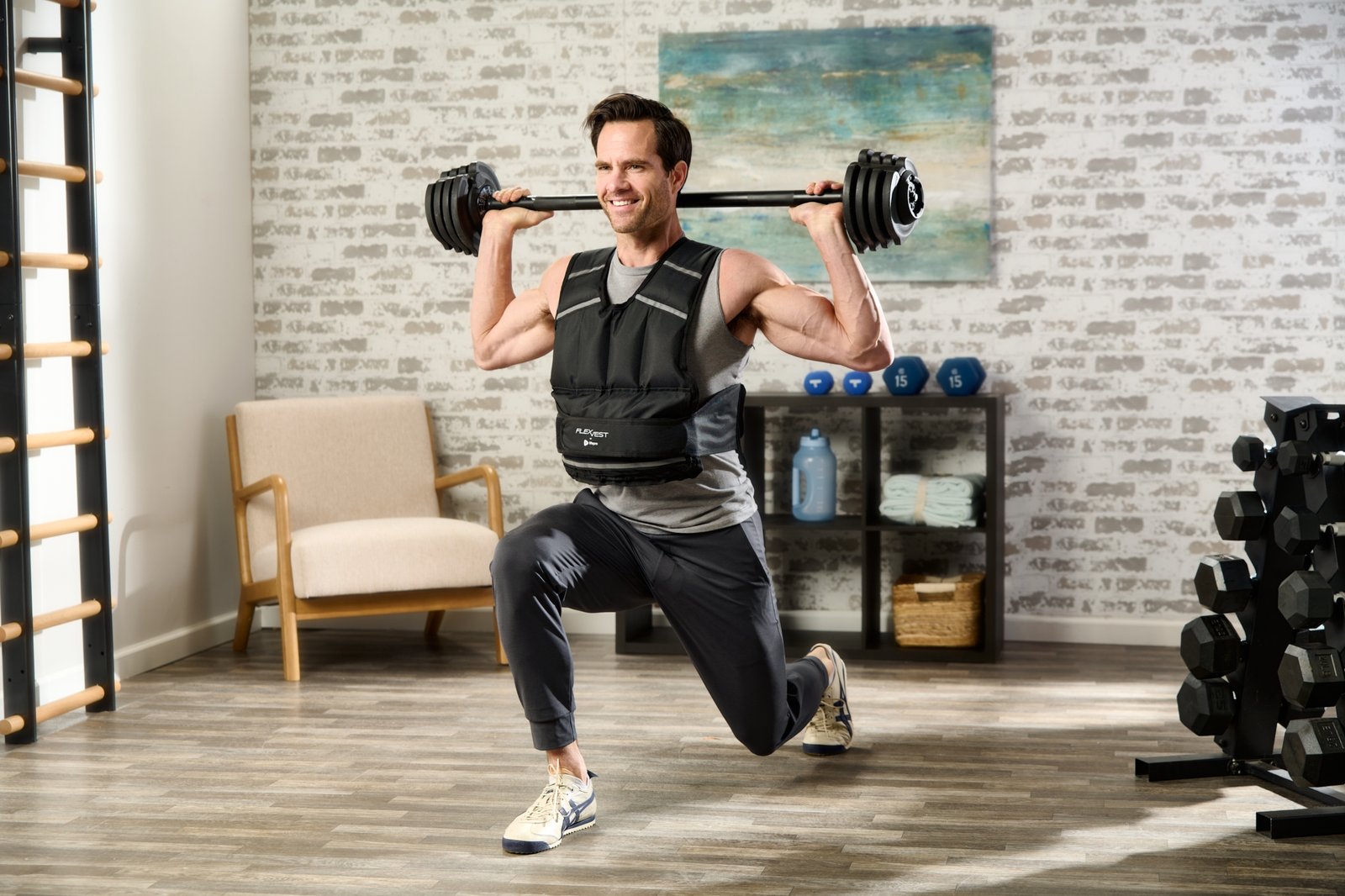 product lifestyle photography of male model in room set with weight vest on lifting barbell over shoulder while kneeling
